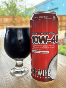 16oz can of 10W-40 Coconut Chocolate Bar placed next to 12oz draft pour of the beer